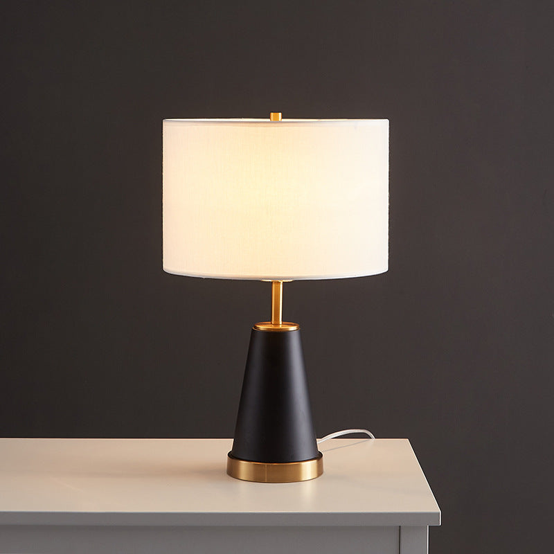 Modern minimalist bedside lamp with warm light and simple silhouette for calm bedroom ambience
